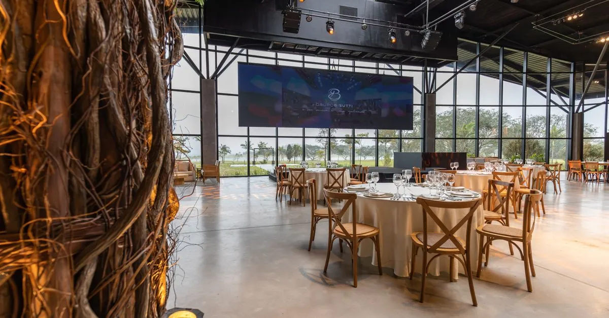 Luxurious banquet hall with glass walls and round tables